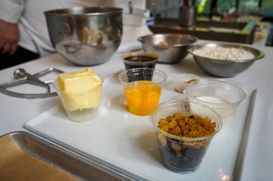 Small bowls and cups filled with ingredients in a kitchen.